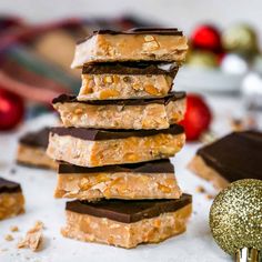 a stack of chocolate and almond bars next to a christmas ornament