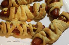 hot dogs wrapped in pastry on a white plate