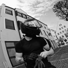 a man riding a skateboard down the side of a street next to a tall building