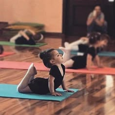 two young children are practicing yoga on mats