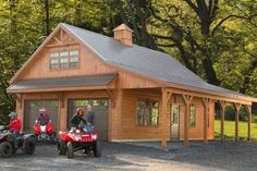 two people on four wheelers in front of a log cabin with an attached garage