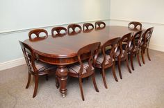 a large wooden table and chairs in a room with carpeted flooring on the floor