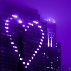 a large building with lots of windows lit up in the dark night sky, and some lights shining down on it