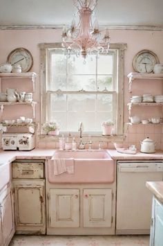 an old fashioned kitchen with pink walls and cabinets