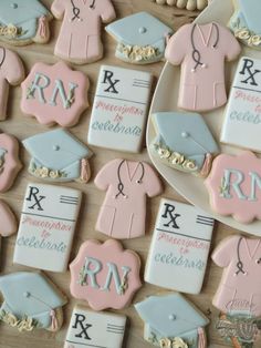 decorated cookies are arranged in the shape of graduation caps, gowns and other items