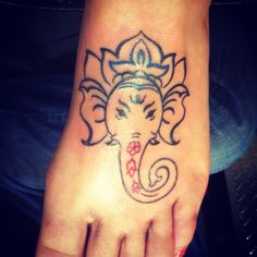 an elephant tattoo on the foot of a person