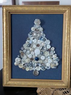 a christmas tree made out of buttons in a frame