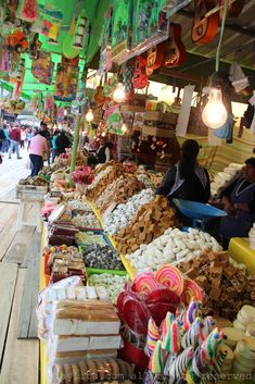 an outdoor market filled with lots of food