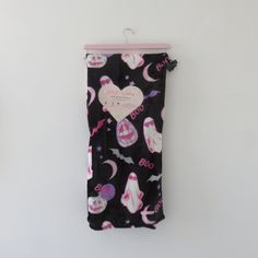 a black and pink towel hanging on the wall