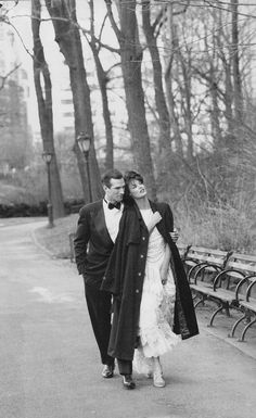 black and white photograph of a couple walking in the park