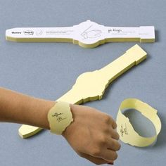 a person's arm and wrist with sticky notes attached to the wristbands