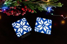 two blue and white squares are sitting on a table