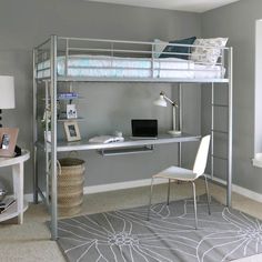 a metal bunk bed with desk underneath it