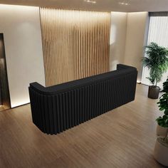 a large black radiator sitting in the middle of a room next to a plant