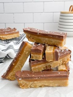 several pieces of chocolate and peanut butter bars stacked on top of each other