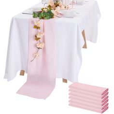 the table is set with pink napkins and place settings