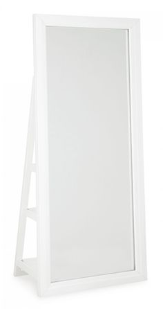 a white framed mirror sitting on top of a table