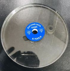 a blue and black object on top of a glass plate with words reading raytimelay germs 4 tools