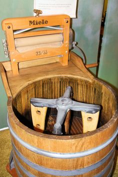 a wooden barrel with tools in it and a sign on the top that says mile