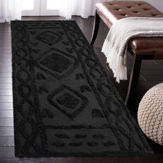 a large black rug in a living room