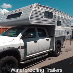 a white truck with a camper attached to it's bed