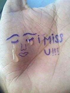 a hand with writing on it that says i miss u and the face of a man's head