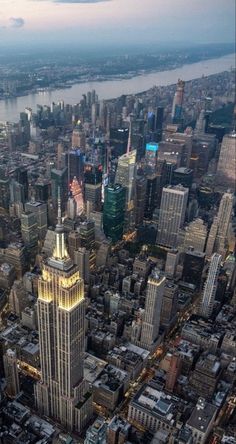 an aerial view of new york city with the empire building in the foreground and other tall buildings