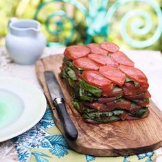 a wooden cutting board topped with lots of food