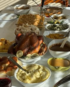 a table full of food including turkey, mashed potatoes and other condiments