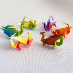 three origami cranes are sitting on the table