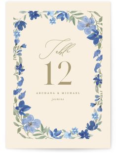 a blue floral frame with the number twelve on it is displayed in front of a white background