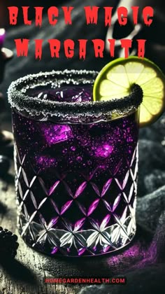 black magic margarita with lime on the rim and purple liquid in it, next to a lemon slice