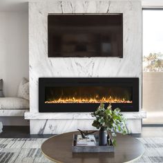 a living room with a fireplace and television mounted on the wall above it's mantle