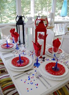 the table is set with red, white and blue place settings for fourth of july