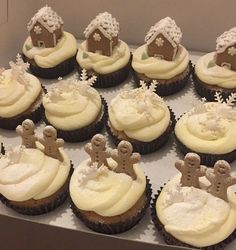 cupcakes with frosting and gingerbread decorations in a box