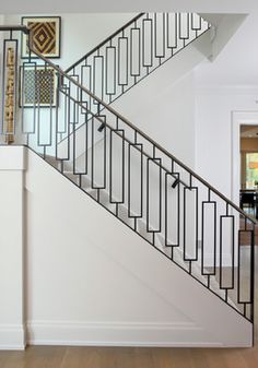 a staircase in a house with white walls and wood floors