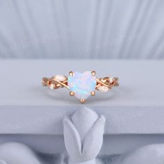 a white opal ring sitting on top of a table