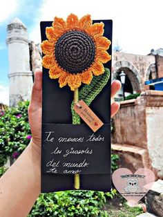 someone is holding up a card with a sunflower on it and the words in spanish are