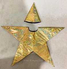 a gold star shaped brooch sitting on top of a table