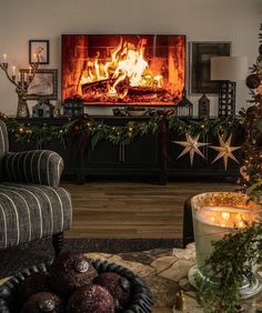 a living room filled with furniture and a fire place covered in christmas decorations, next to a fireplace