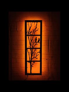 a window with birds on it lit up in the dark