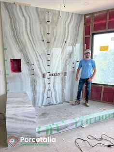 a man standing on top of a floor next to a wall covered in white marble