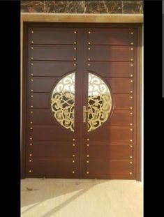 two brown doors with gold designs on them