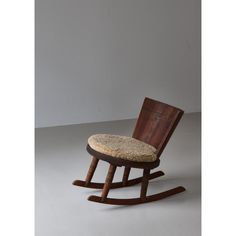 a wooden rocking chair with a cushion on it's seat and backrests