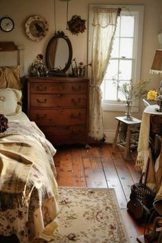 a bed room with a neatly made bed next to a dresser and mirror on the wall