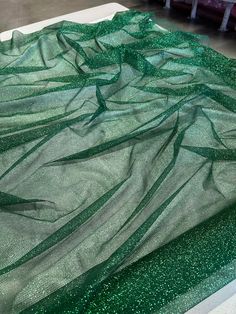 This is beautiful hunter green glitter on hunter green mesh/tulle. The fabric has shiny and sparkly look because of the glitter. The fabric serves multipurpose and can be used for dresses, gowns proms, decor, and many more.  PLEASE NOTE : Although there is no compromise with the quality of the fabric, some might notice falling off the GLITTER while handling, which is quite common with these kinds of fabric. CLR: Hunter Green WIDTH: 60/62 INCHES                   LENGTH : 36 INCHES (1 YARD) CONTENT/COMPOSITION: Polyester 100% USAGE: Bridal & Wedding Dress, Evening Gowns, Partywear, Prom, Costume, Décor, Hair Accessories, Bags, DIY CARE INSTRUCTIONS: Dry clean.  Please note image colors may vary per screen. The PRICE offered is PER YARD.  Add the yardage to your cart and it will be cut in on Prom Costume, Kinds Of Fabric, Gown Prom, Price Offer, Green Glitter, Bridal Wedding Dresses, Hunter Green, Evening Gowns, Angeles