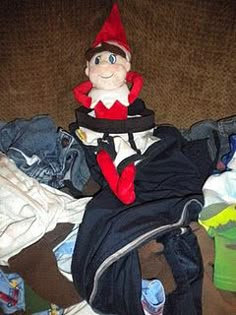 an elf is sitting on the couch with clothes