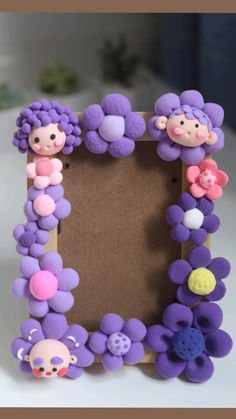 there is a purple frame made out of plastic flowers and sheeps on the side