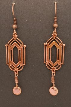 Art Deco Style Dangle Earrings are metal stampings in antique copper tone with elegant surface detail. There is an etched copper tone lentil dangle. Earrings dangle from ball and coil ear wires in antique brass tone. A Takeen Arts original. Designed and created by TLP and staff for Takeen Arts. Item E875. Nickel-free Antique Gold Copper Jewelry, Antique Gold Nickel-free Copper Earrings, Nickel-free Antique Gold Copper Earrings, Antique Gold Copper Drop Earrings, Antique Finish Copper Dangle Earrings, Antique Gold Copper Earrings Nickel Free, Bronze Antique Finish Dangle Earrings, Antique Gold Copper Earrings With Antique Finish, Antique Finish Copper Drop Earrings