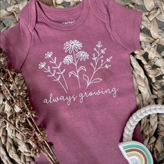 Always Growing Baby Onesie. Perfect Onesie For That New Flower Loving Baby! These Are Made Using A Heat Press And Premium Vinyl. These Will Be Printed On Carters 100% Cotton Bodysuits. These Come In A Burnt Crimson Color Onesie With White Font. Feel Free To Ask If You Have A Specific Color Option). Comes In Sizes Newborn To 12 Months. Only Short Sleeves Remaining. Machine Wash Inside Out Cold And Hang Dry Or Tumble Dry On Low Heat. Care Instructions Will Be Included. Onesie Decorating Ideas, Cricut Onesie Ideas, Baby Onesies Cricut, Cricut Baby Onesie, Baby Onsies Ideas, Fall Onesies, Baby Onesies Girl, Onesie Decorating, Onesie Ideas